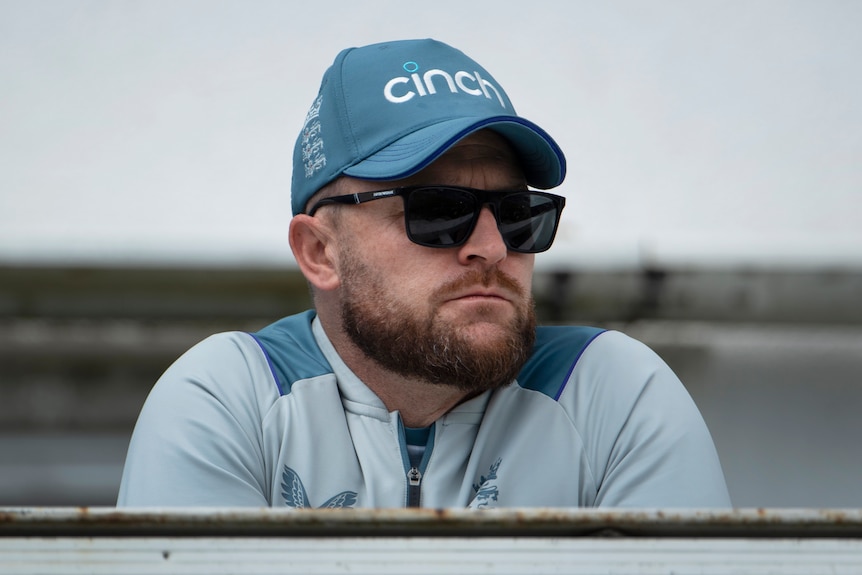 Brendon McCullum in sunglasses looks to one side