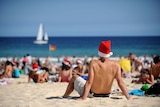 Tourists and locals assemble on Bondi Beach