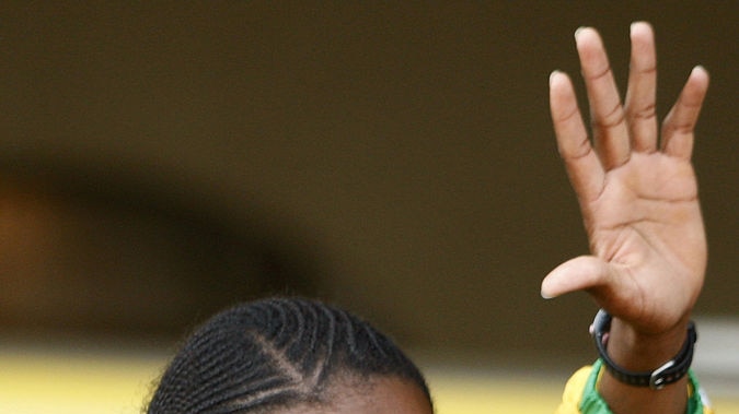 Caster Semenya gestures to fans at S Africa airport