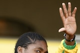 Caster Semenya gestures to fans at S Africa airport