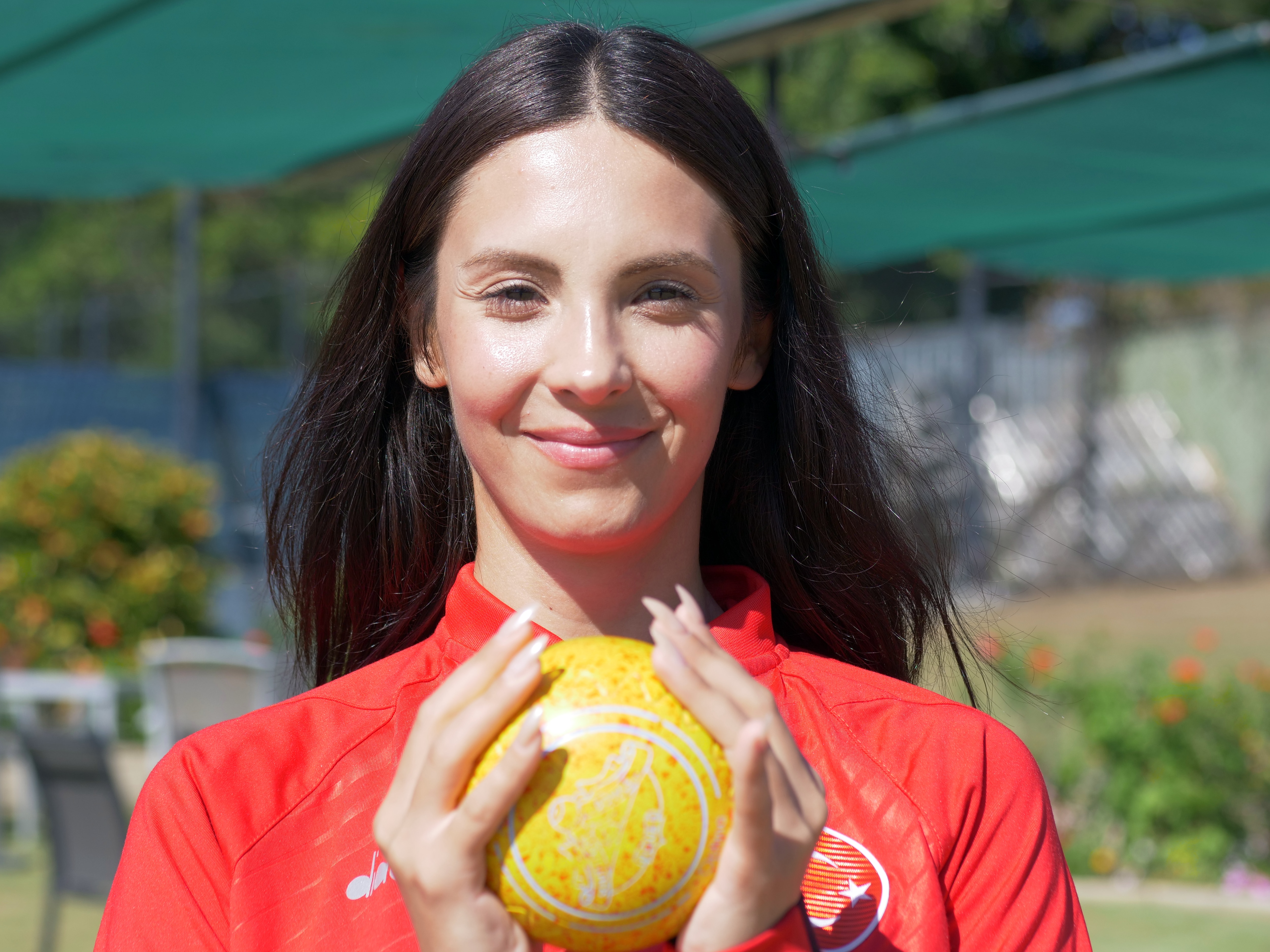 woman smiling while holding bowl