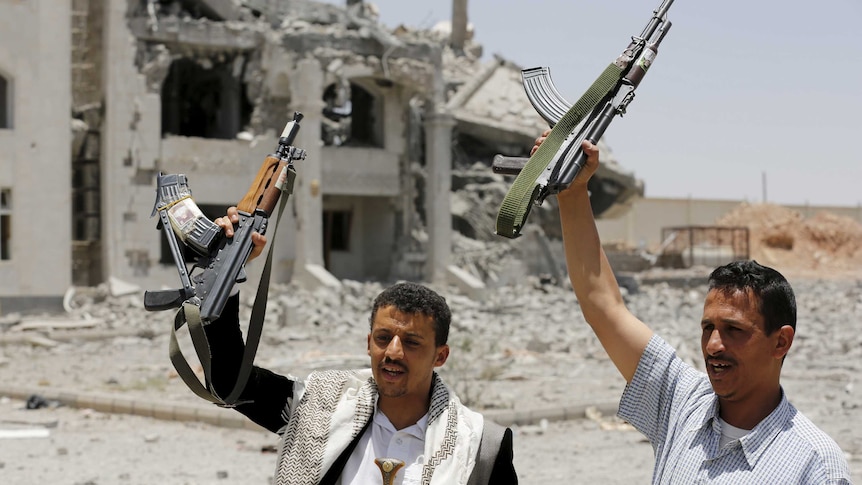 Houthi militants gesture in Sanaa