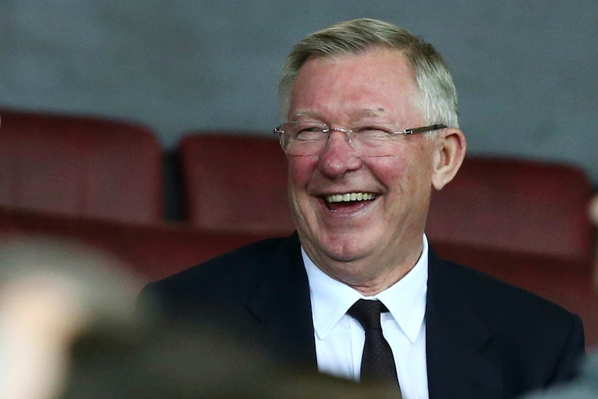 Sir Alex Ferguson smiles in the stands