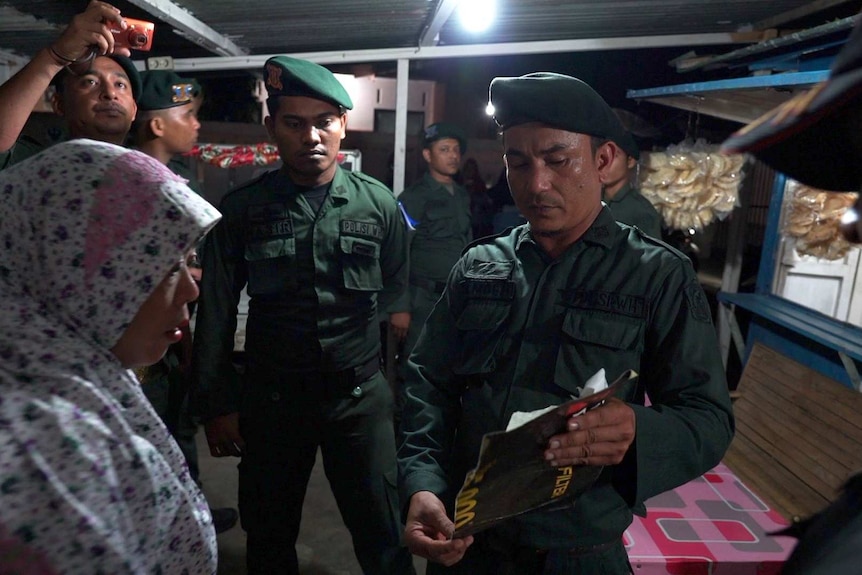 Woman questioned by several officers in a house in aceh