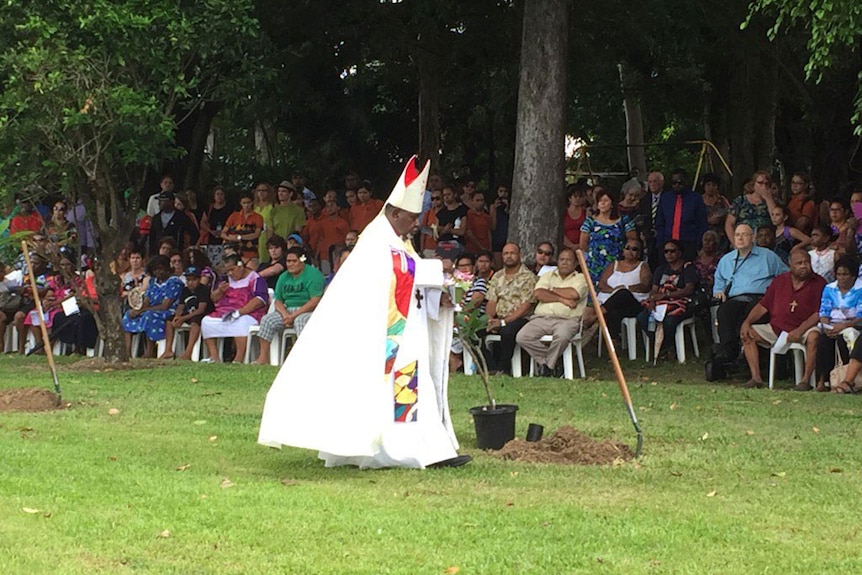 Bishop Saibo Mabo performs a cleansing ceremony at the memorial service