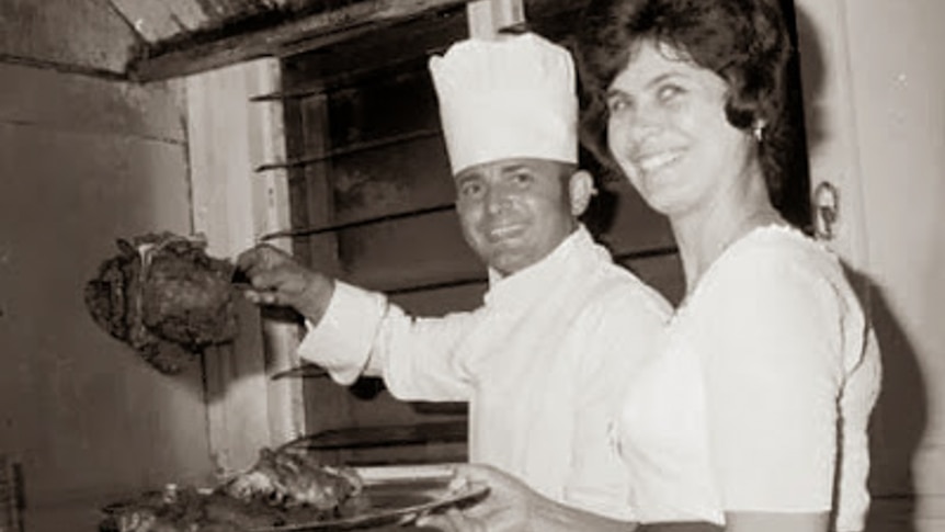 A chef and a waitress serving food.