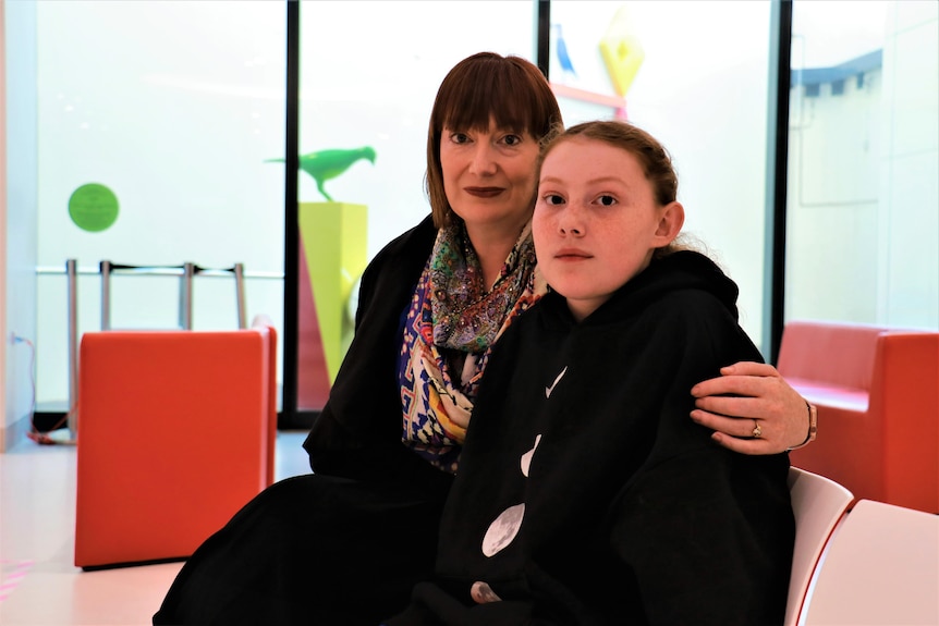 Toni Grayson sitting in a hospital waiting area with her mother Kate. 