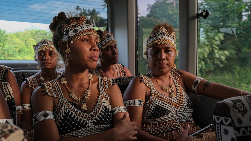 Four of the Faeni dancers sitting in the bus, heading for their final dress rehearsal in the Solomons.