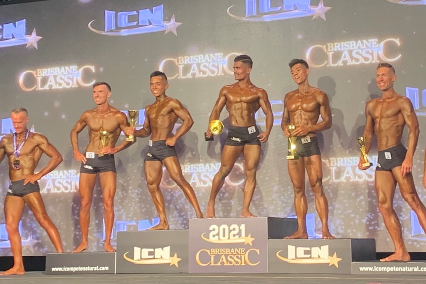 Noor on the podium with other body builders.