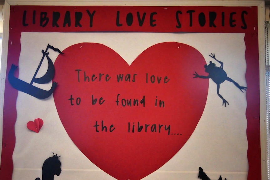A close-up shot of a sign which says 'Library love stories' and 'There was love to be found in the library...'.