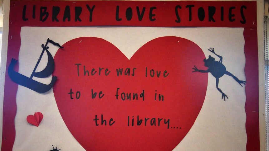 A close-up shot of a sign which says 'Library love stories' and 'There was love to be found in the library...'.