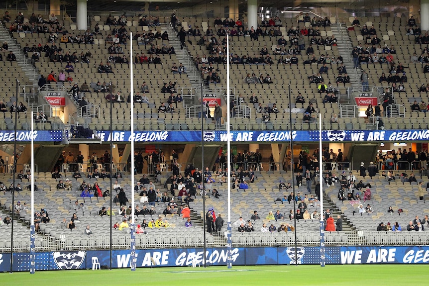 A shot of the Perth Stadium crowd observing social distancing behind the goal posts before the Geelong-Collingwood AFL match.