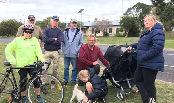 seven residents of small town of Hawkesdale stand together looking at camera