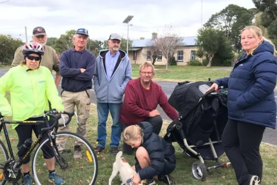 seven residents of small town of Hawkesdale stand together looking at camera