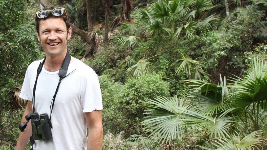Senior Ecologist Oisin Sweeney standing in a  rainforest