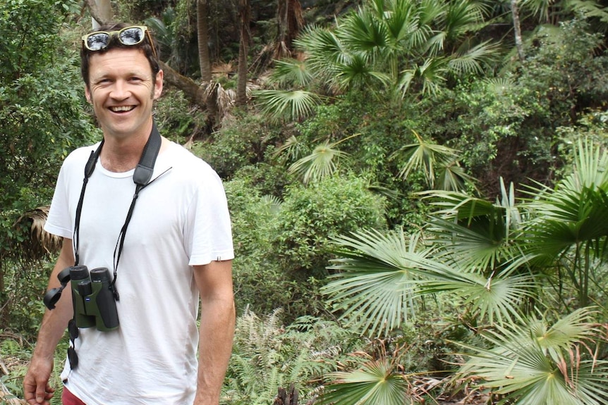 Senior Ecologist Oisin Sweeney standing in a  rainforest