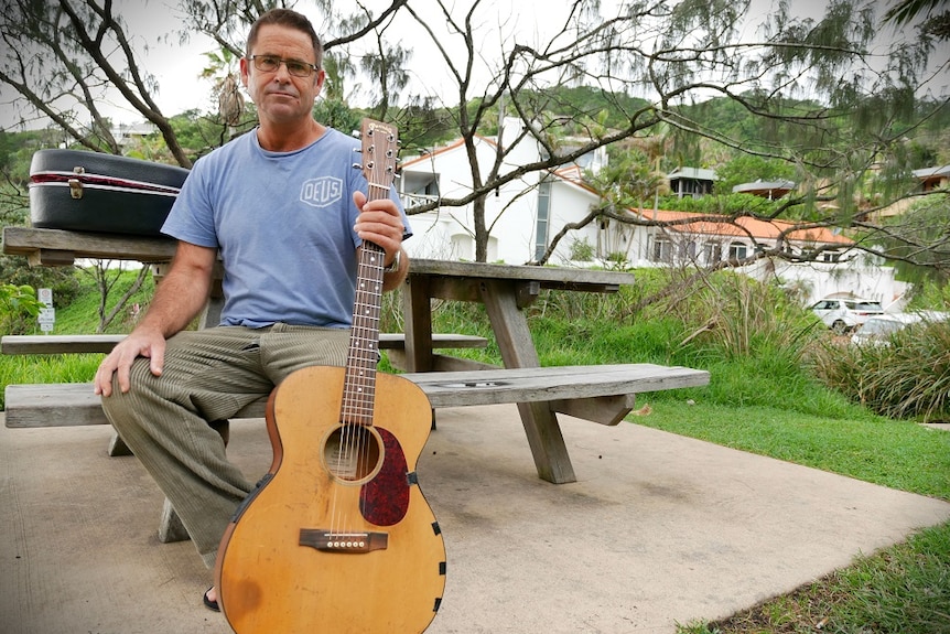 Local Byron musician Fintan Callaghan poses with his guitar.