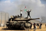 Palestinians wave their national flag and celebrate.