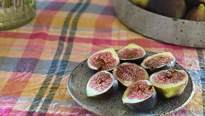 Fresh figs on table in stone bowl.