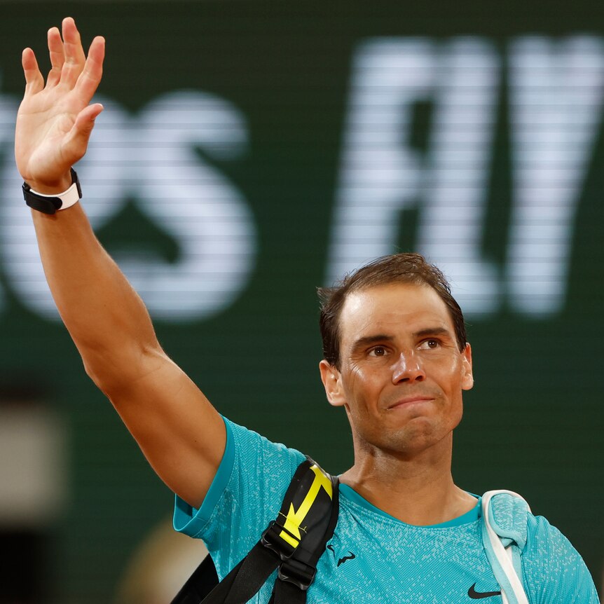 Rafael Nadal waves goodbye to fans on the court at Roland Garros.