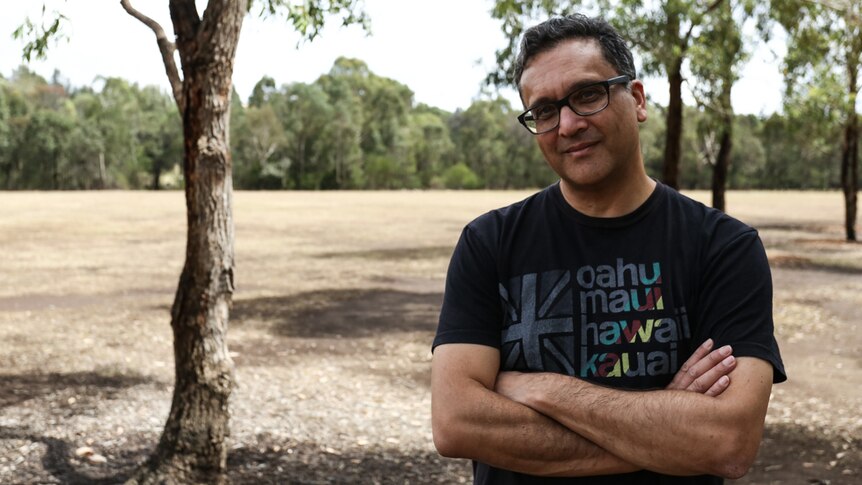 Author Greg de Moore pictured in a park in Parramatta in Sydney.