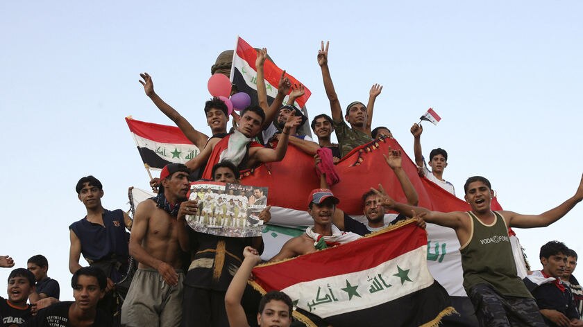 Example: Iraqis celebrate in Baghdad after their Asian Cup win