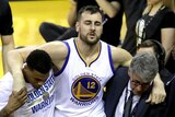Andrew Bogut carried off with a knee injury