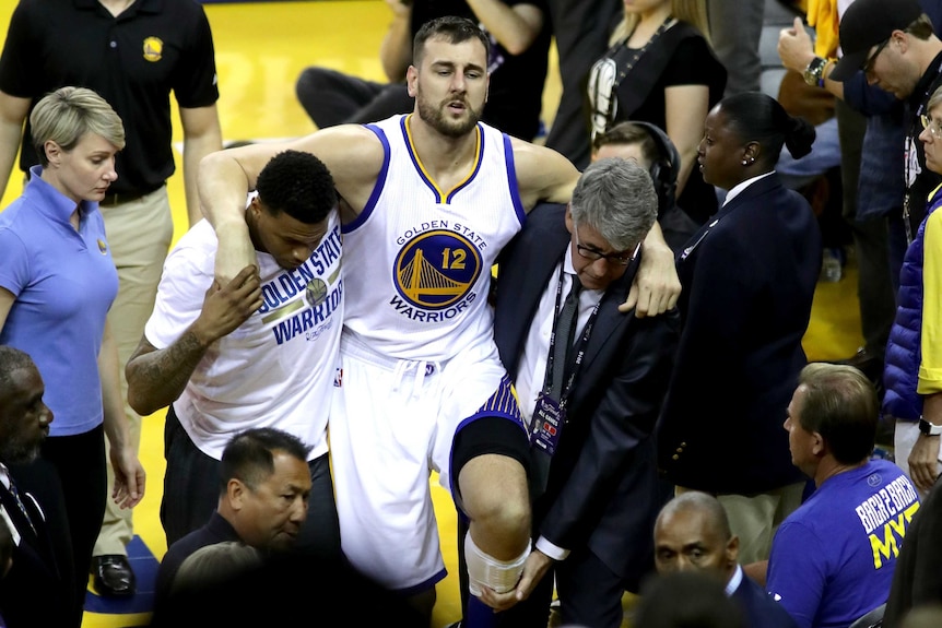 Andrew Bogut carried off with a knee injury