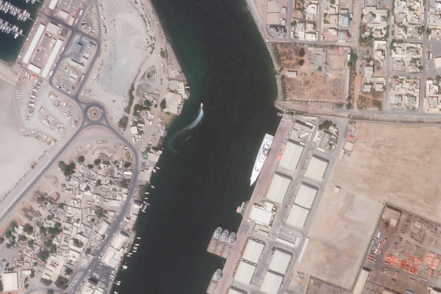Satellite image shows superyacht moored in waterway.