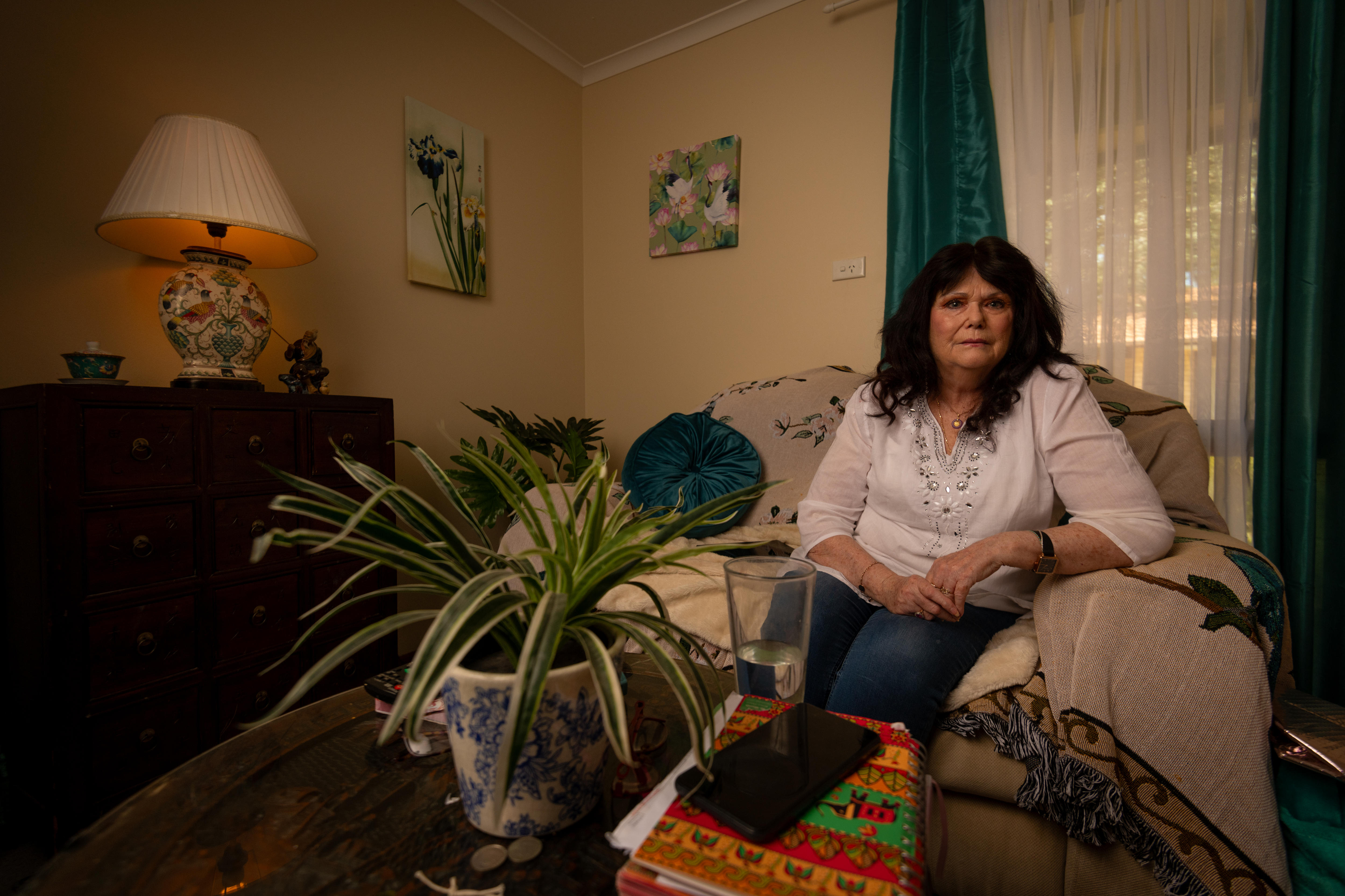 Elaine sitting on the couch in her living room.
