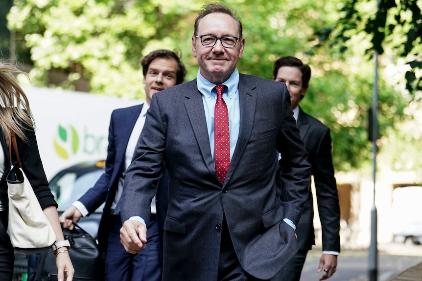 Kevin Spacey arrives at a London court wearing a tie.