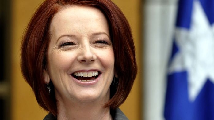 Prime Minister Julia Gillard laughs during a press conference (AAP: Alan Porritt)