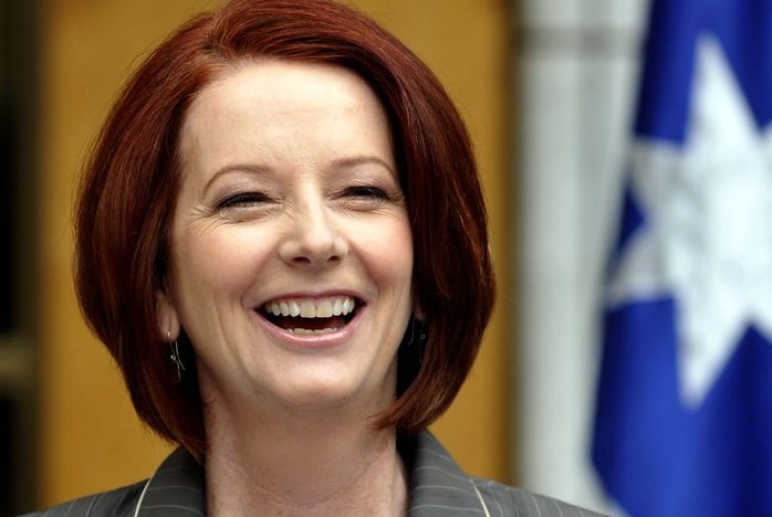 Prime Minister Julia Gillard laughs during a press conference (AAP: Alan Porritt)