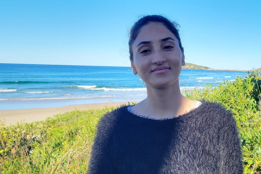 A woman at beach, smiling