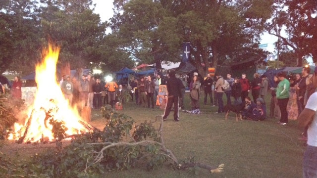 Protesters stand around bonfire at Brisbane tent embassy at first light on May 16.