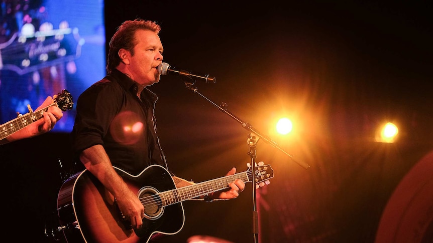 Troy Cassar-Daley performing on stage at the Tamworth Golden Guitars.