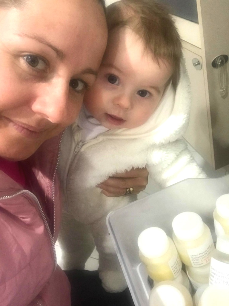 Mum, baby and small bottles of frozen breastmilk