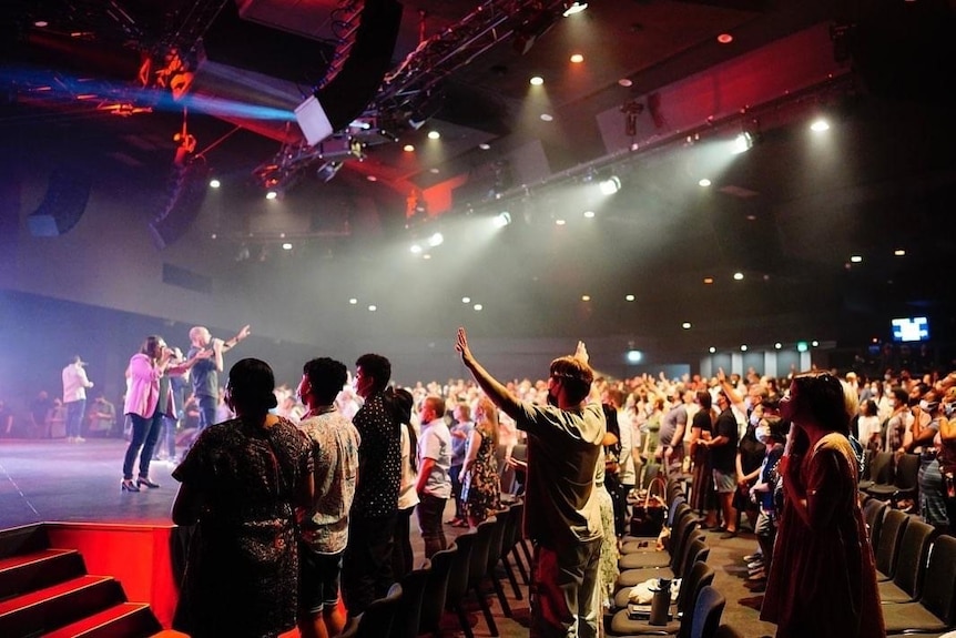 A Hillsong church service with people wearing masks