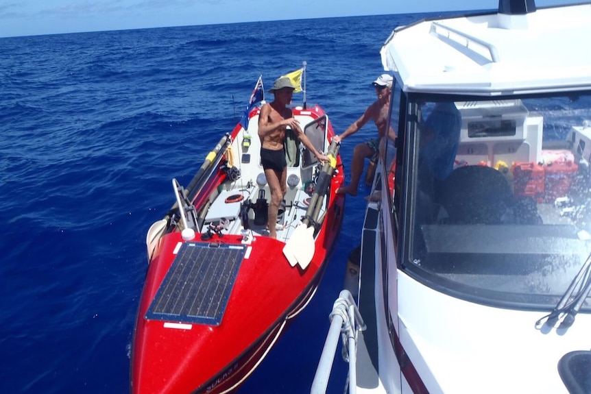 British solo ocean rower John Beeden meets a support board near Vanuata in the Pacific Ocean in late 2015