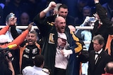 Tyson Fury (C) celebrates after beating Wladimir Klitschko to win world heavyweight boxing title.