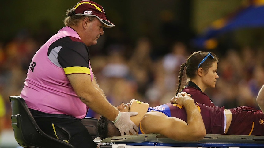 Brisbane's Stefan Martin is stretchered off against Gold Coast at the Gabba on April 16, 2016.