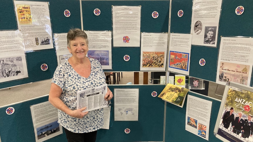 Zita stands in front of a display of war history at Tumut Library.