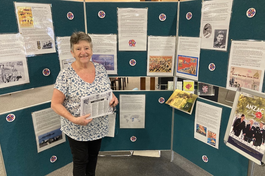 Zita stands in front of a display of war history at Tumut Library.