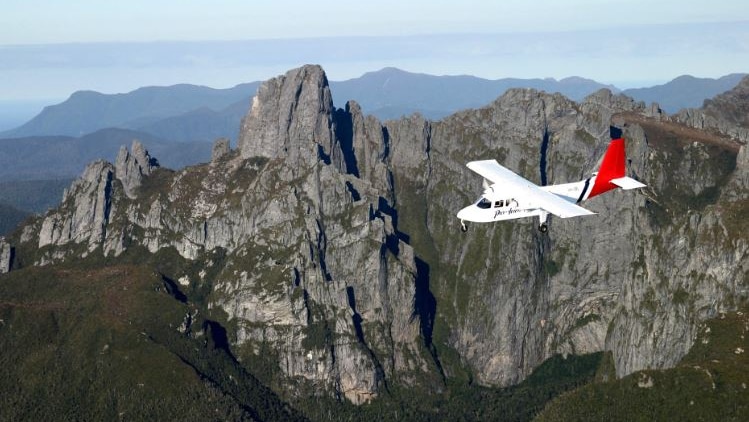 Par Avion plane flies past Federation Peak, Tasmania.