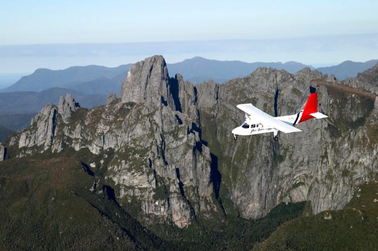 Par Avion plane flies past Federation Peak, Tasmania.