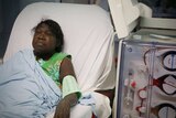 Jacqueline Amagula lies in a hospital bed having dialysis,
