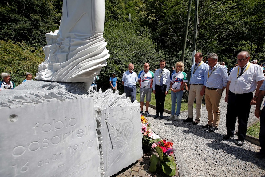 Tour de France director Christian Prudhomme at a monument to Italian cyclist Fabio Casartelli.