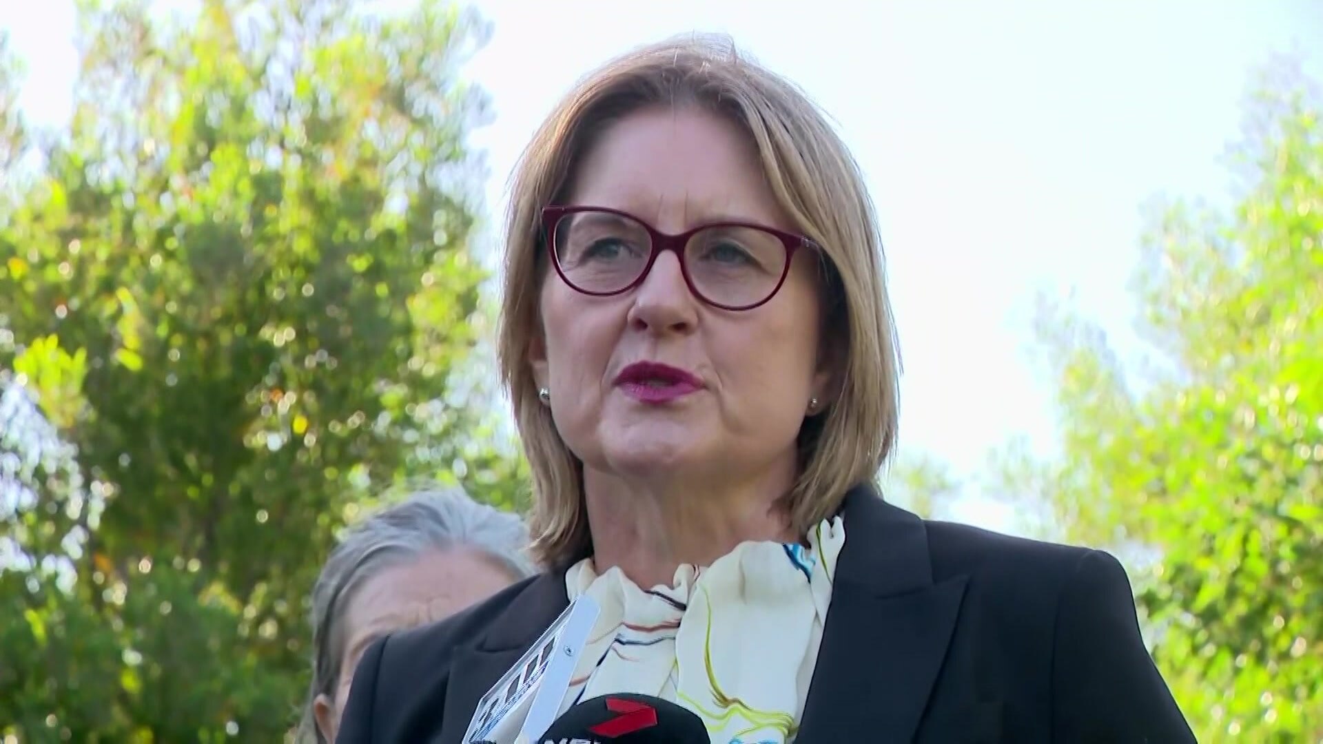 Jacinta Allan speaks into a microphone.