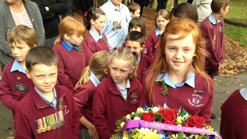 Children from Riverside Primary School prepare to lay a wreath at an Anzac day service in Launceston.