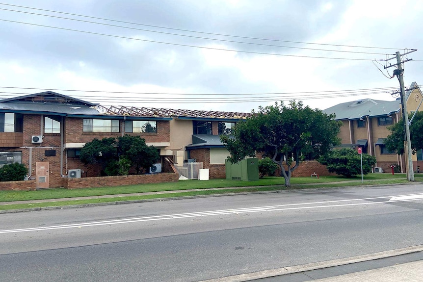 A brick building with its roof torn off.